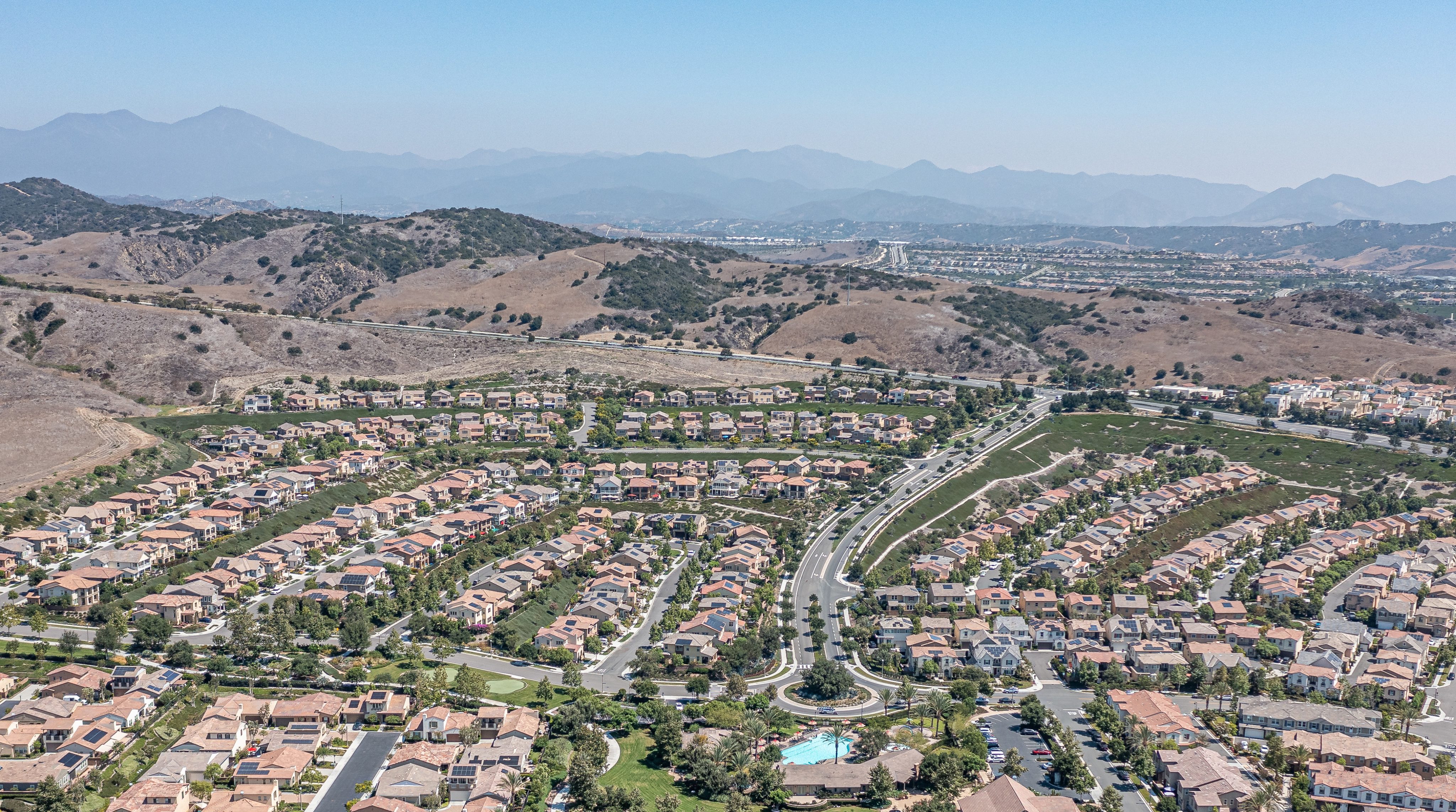 Aerial of a large neighborhood with hills in the background
